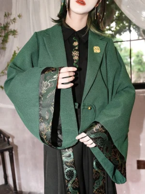 Close-up of dark green New Chinese Style cropped jacket with wide sleeves, dragon and floral embroidered cuff trim, front hanging details and decorative metal button