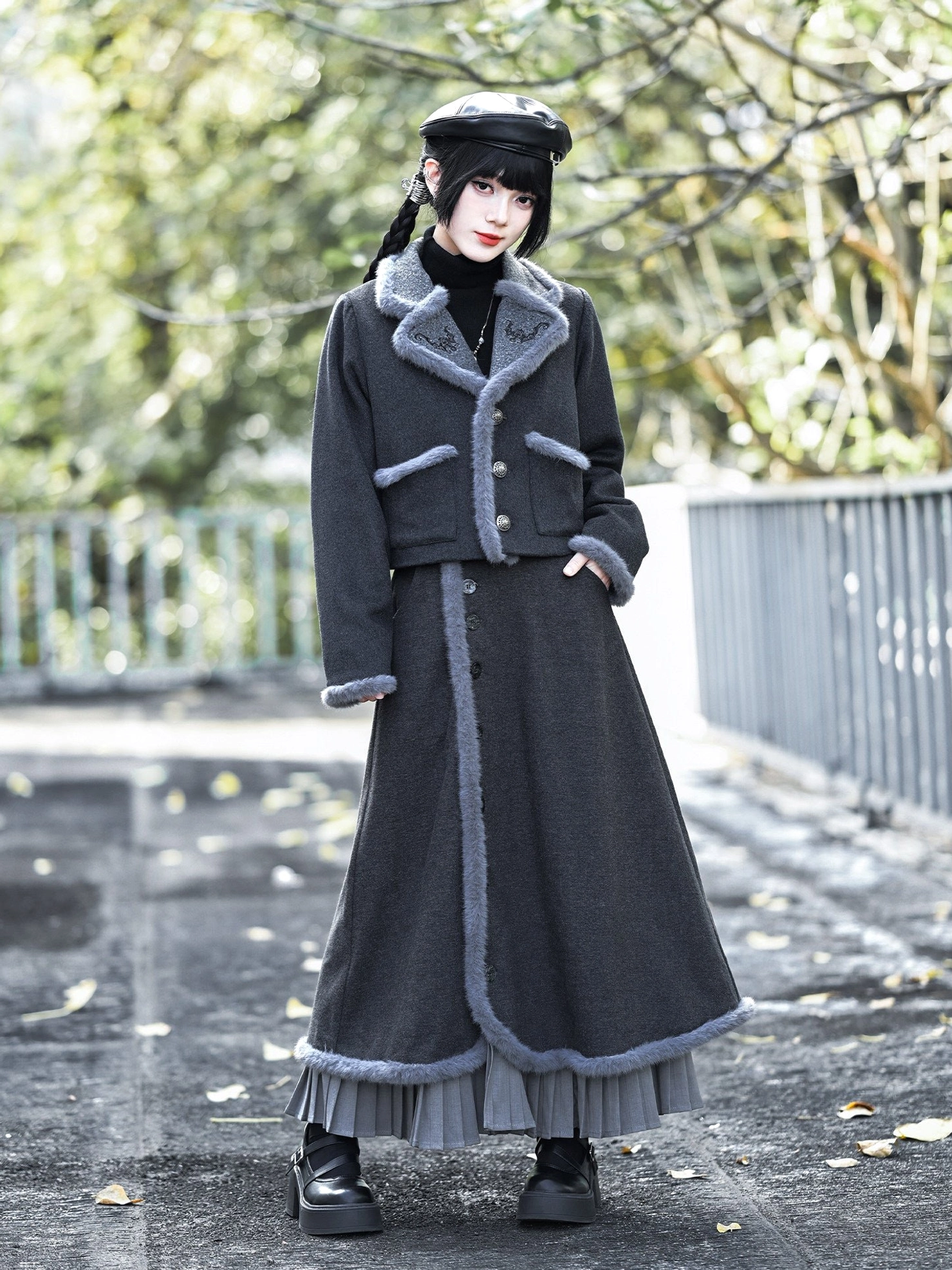 Back three-quarter view of a dark grey Chinese-style modern Hanfu jacket styled with a flowing long skirt and layered vintage outfit