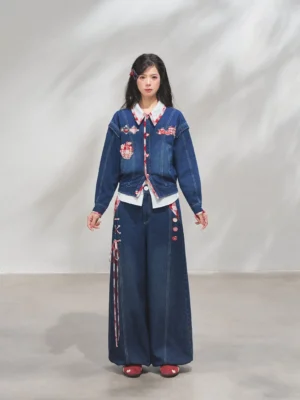 Modern Hanfu denim jacket and wide-leg trousers set with apple embroidery, red plaid trim, and side drawstring details styled with red loafers