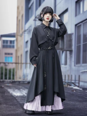 Full-body front view of modern Hanfu double-layer pleated wide-leg culottes with asymmetric black outer layer, light purple patterned underlayer, decorative waist belt, and hanging chain styled on an urban street