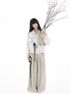 Modern Hanfu embroidered ivory cropped jacket and apricot wide-leg pants full set front view in a minimalist white studio