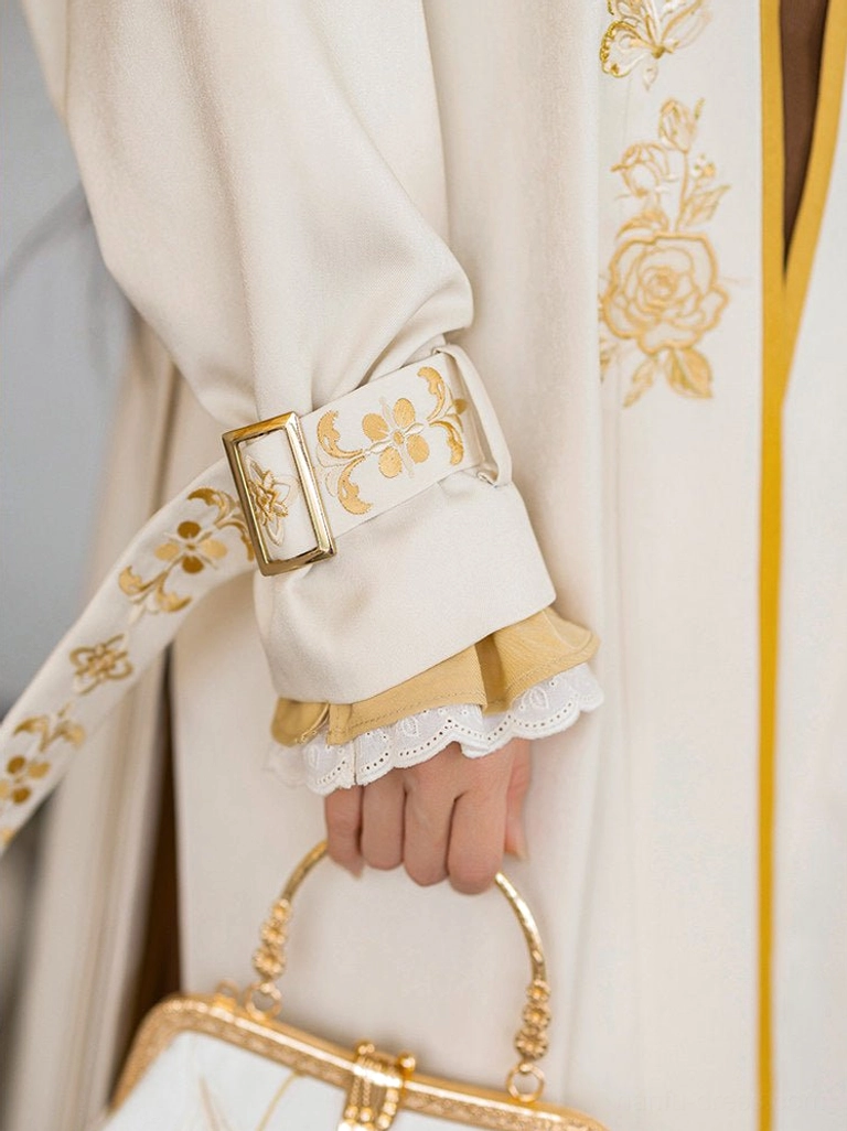 Detailed view of modern Hanfu sleeve cuff and decorative waist belt with floral embroidery, ruffled trim, and adjustable metal buckle