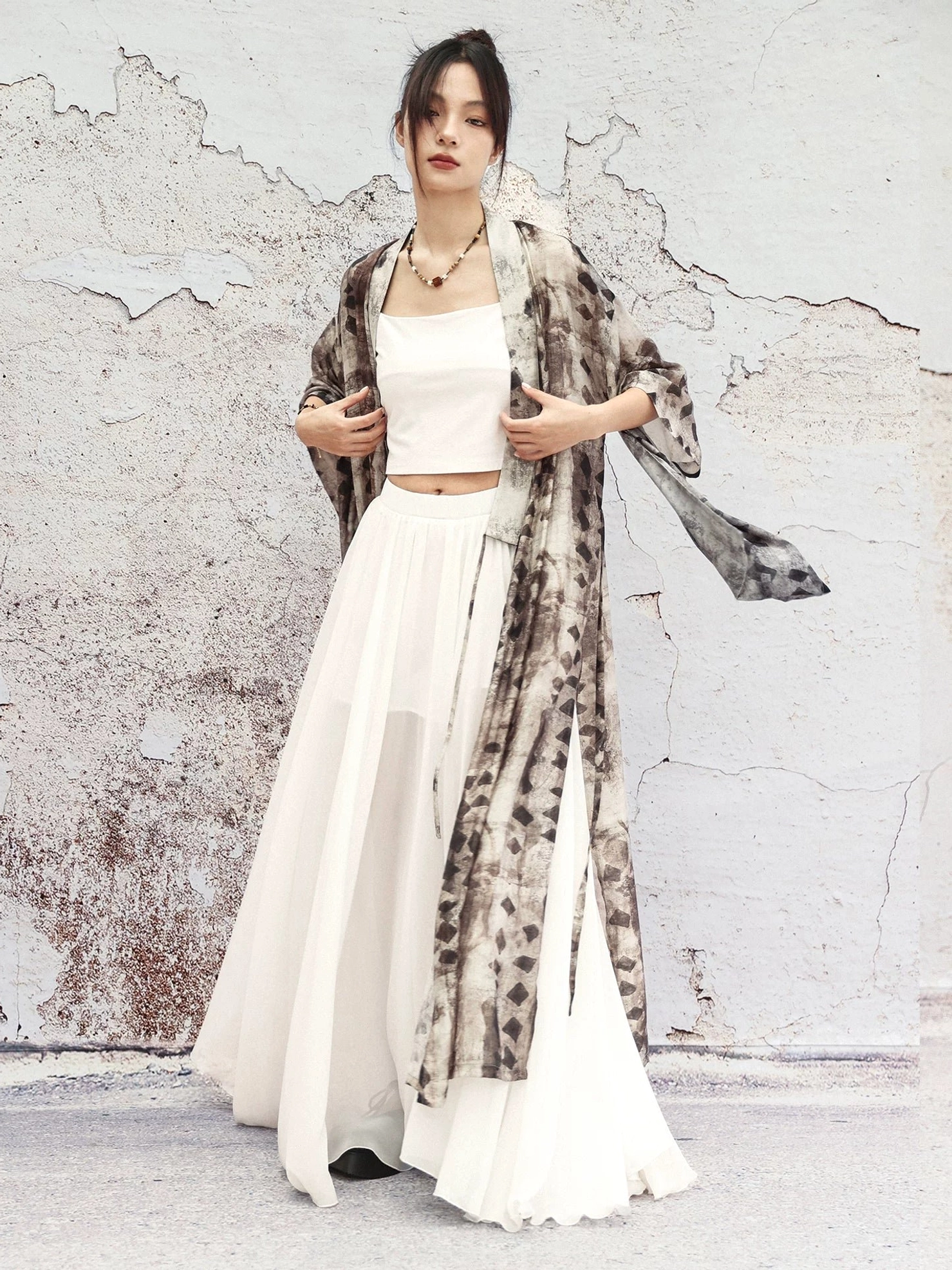 Modern Hanfu geometric print cardigan styled with a white cropped top and flowing white maxi skirt for an elegant layered outfit