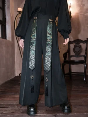 Black Modern Hanfu high-waist wide-leg pants with green gold snake-pattern embroidered straps, tassels, metal buttons, and loose draped legs