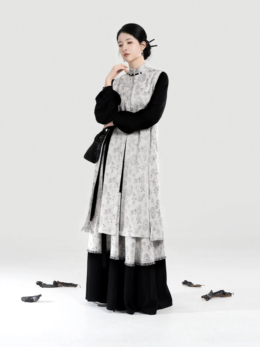 Side view of grey floral modern Hanfu bijia vest with black side drawstrings bow sleeve top and long layered skirt