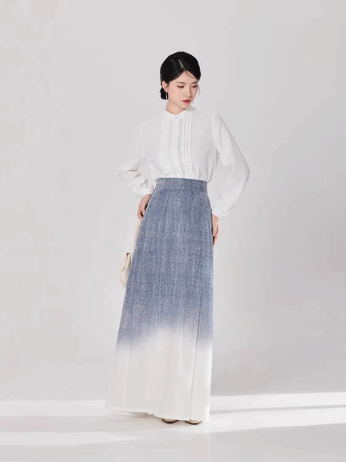 Three-quarter front view of a modern Hanfu set showing the high-waisted fit and elegant pleated skirt silhouette
