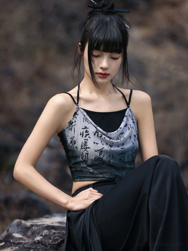 Modern Hanfu cropped camisole styled with wide leg pants in a rocky mountain setting, featuring grey black ink wash ombre and Chinese calligraphy print