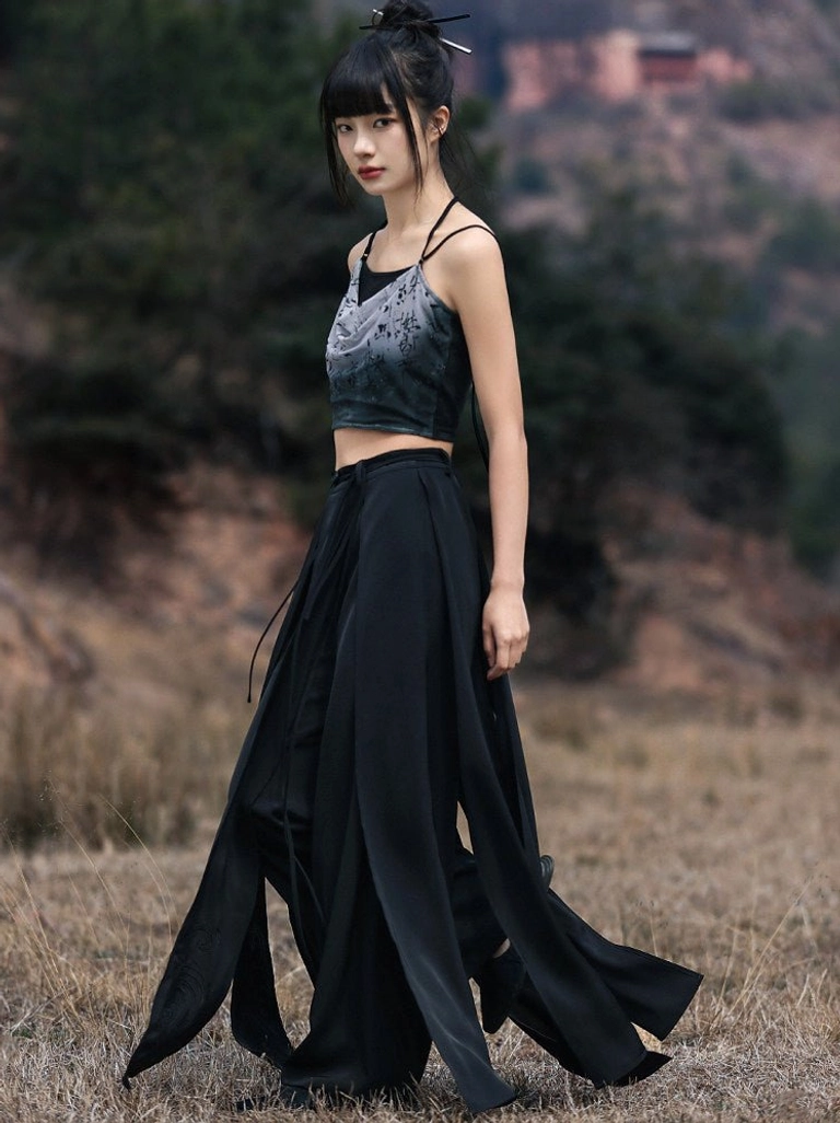 Side view of ink wash Chinese calligraphy print Modern Hanfu camisole styled with flowing black split hem wide leg pants outdoors