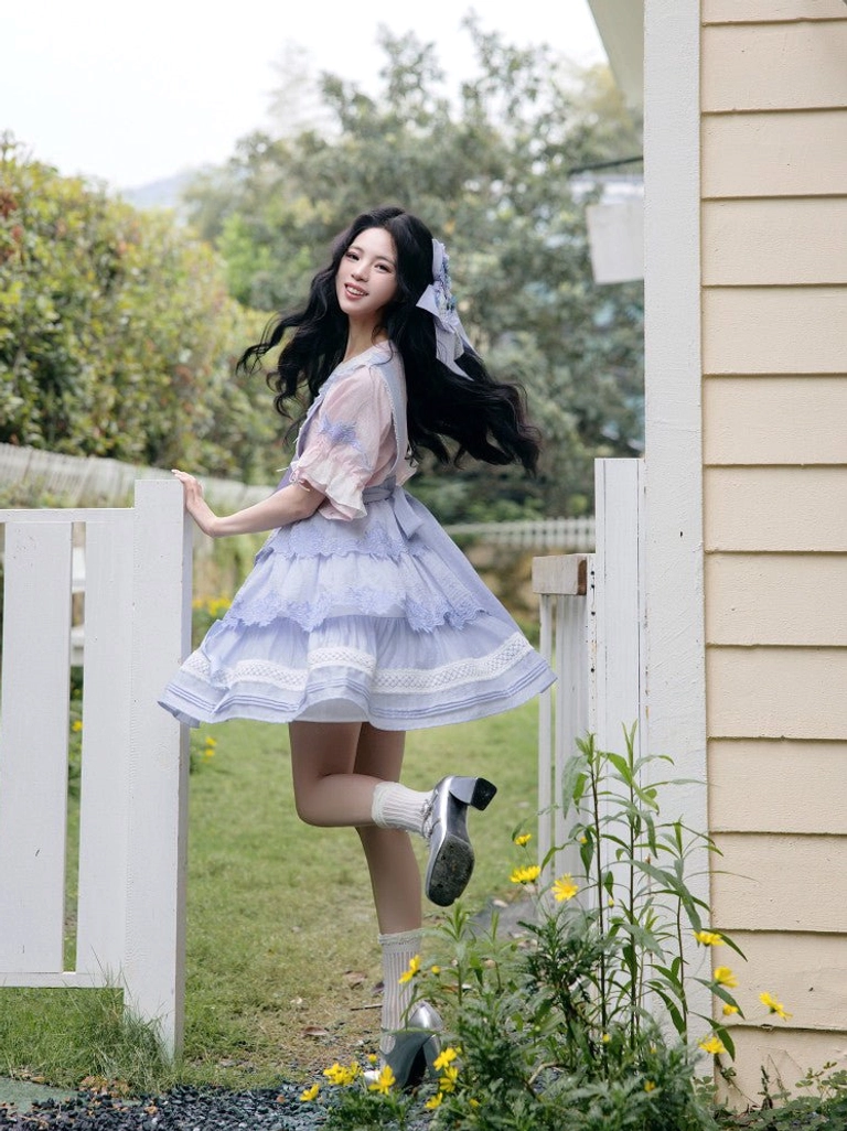 Back side view of a lavender modern Hanfu inspired Lolita summer dress with long dark hair blue hair accessory and playful garden styling
