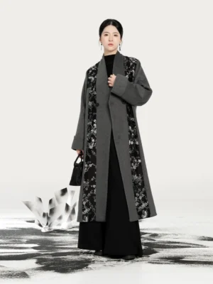 Front full-length view of a modern Hanfu ash grey overcoat with black and silver magpie and plum blossom woven panels, shawl lapel, and relaxed longline silhouette