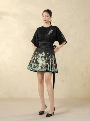 Front view of modern Hanfu mini horse face skirt with green floral landscape print, black waist sash, and coordinated dark top