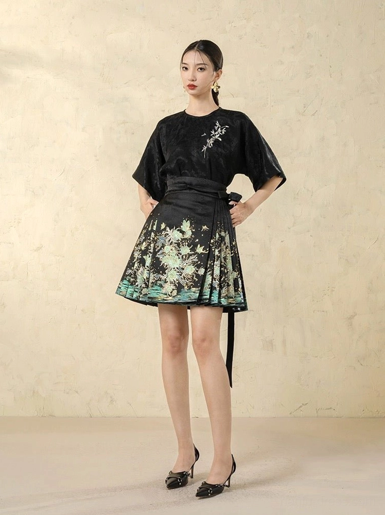 Front view of modern Hanfu mini horse face skirt with green floral landscape print, black waist sash, and coordinated dark top