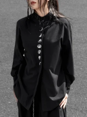 Front close-up of a woman wearing a black modern Hanfu moon phase long sleeve top with stand collar, relaxed fit, celestial front panel, and side metal chain detail