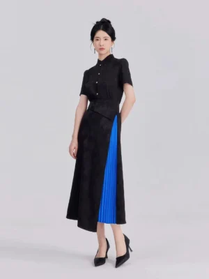 Full-body front view of a woman wearing a black modern Hanfu cropped jacquard shirt and asymmetrical A-line midi skirt with bright blue pleated panel