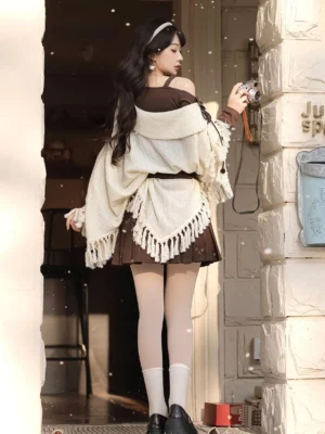 Back view of modern Hanfu off-shoulder knit cloak outfit with asymmetrical cape hem tassel trim and brown mini skirt