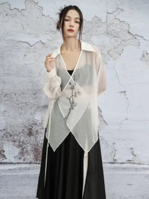 Off-white modern Hanfu sheer cardigan with pine branch embroidery, classic shirt collar, long sleeves, asymmetric hem, and side tie straps styled over a black camisole and long skirt