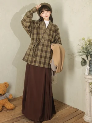 Modern Hanfu olive brown plaid cross-collar wrap jacket front view styled with a dark pleated long skirt and beret