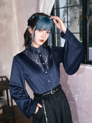 Dark navy modern Hanfu pipa sleeve top with Mandarin collar silver phoenix cloud embroidery pearl buttons and oversized lantern sleeves shown in a three quarter front portrait