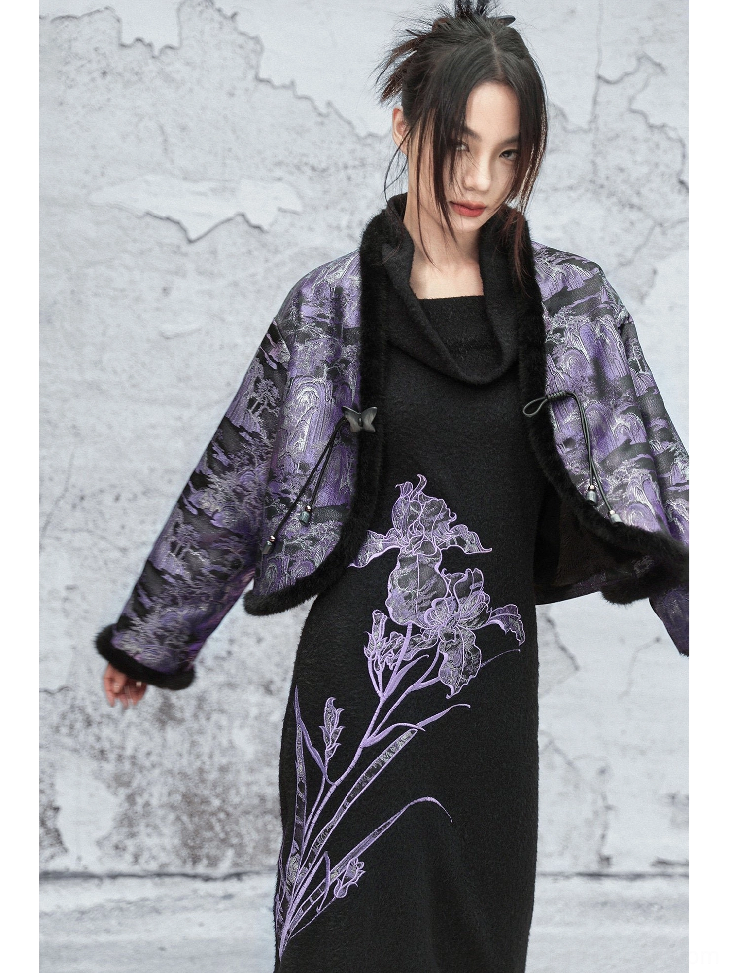 Three-quarter front view of a relaxed modern Hanfu cropped jacket in dark purple jacquard with black fuzzy collar and sleeve edging