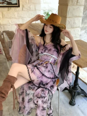 Purple modern Hanfu fairy slip dress with ink-wash print, ruffled asymmetrical hem, black lace trim, beaded waist decoration, and sheer flared sleeves styled in a retro stone-walled cafe