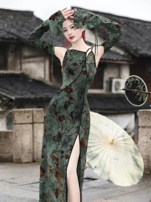 Modern Chinese qipao-inspired Hanfu dress with asymmetrical shoulder cutouts, fitted silhouette, high side slit, and matching flared long sleeves in a traditional Jiangnan town setting