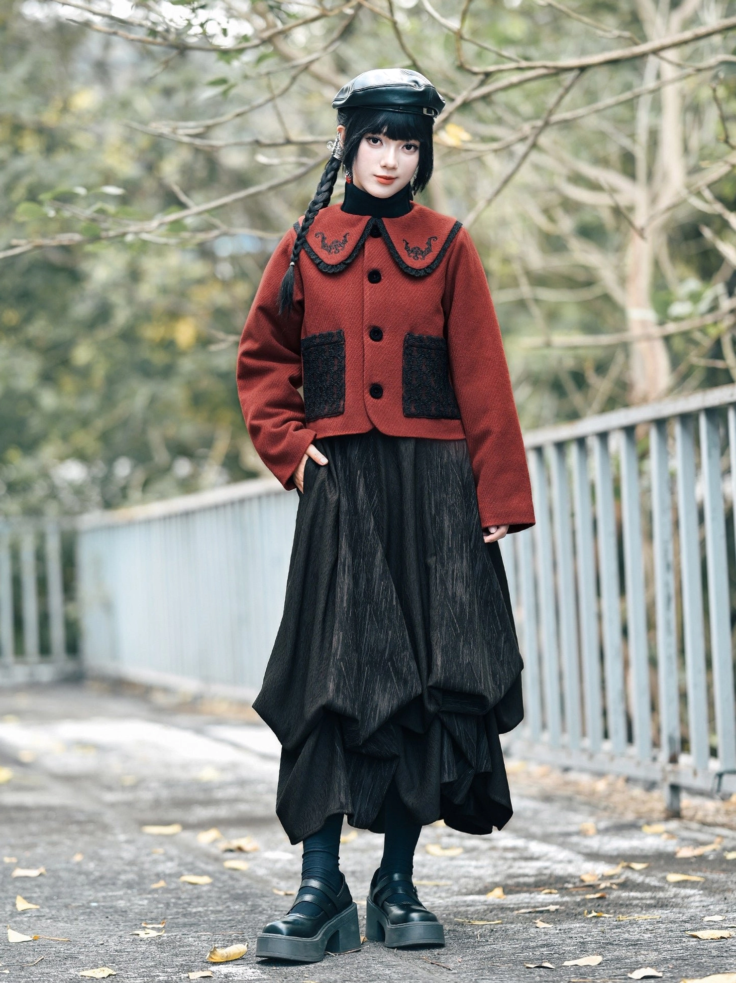 Full-body styling of a red lucky bat embroidered modern Hanfu jacket paired with a high-waisted black skirt and platform loafers