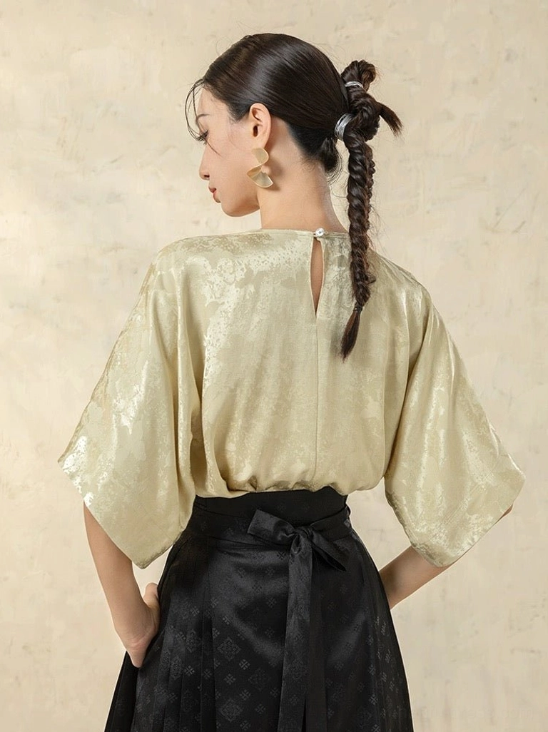 Modern Hanfu satin top shown from the back with jacquard texture, dolman half sleeves, and elegant keyhole button closure at the neckline