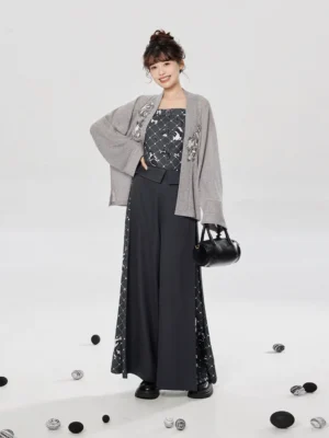Three-quarter view of a modern Hanfu jacket and pants outfit styled with a black handbag and monochrome Chinese-inspired details