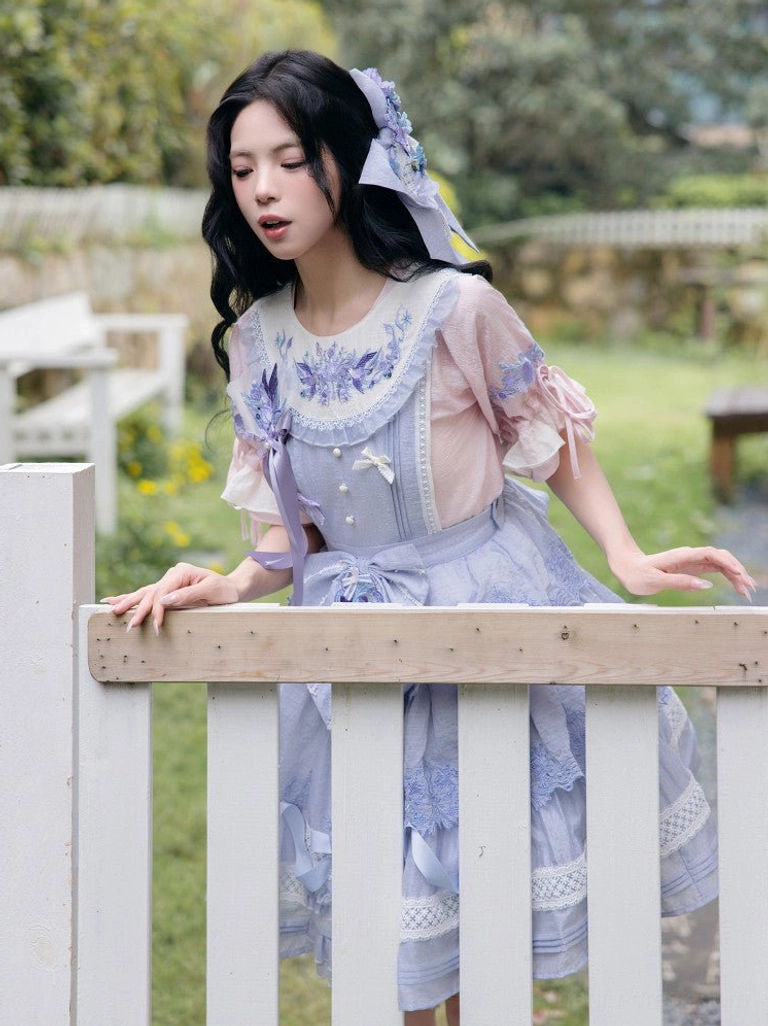 Side view of a sweet Lolita inspired modern Hanfu summer outfit featuring a lavender floral embroidered dress ruffled puff sleeves and lace edging