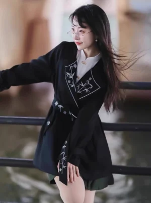 Modern Hanfu Tang-style black embroidered coat with white bamboo lapel embroidery matching waist belt and tailored Chinese-inspired blazer silhouette
