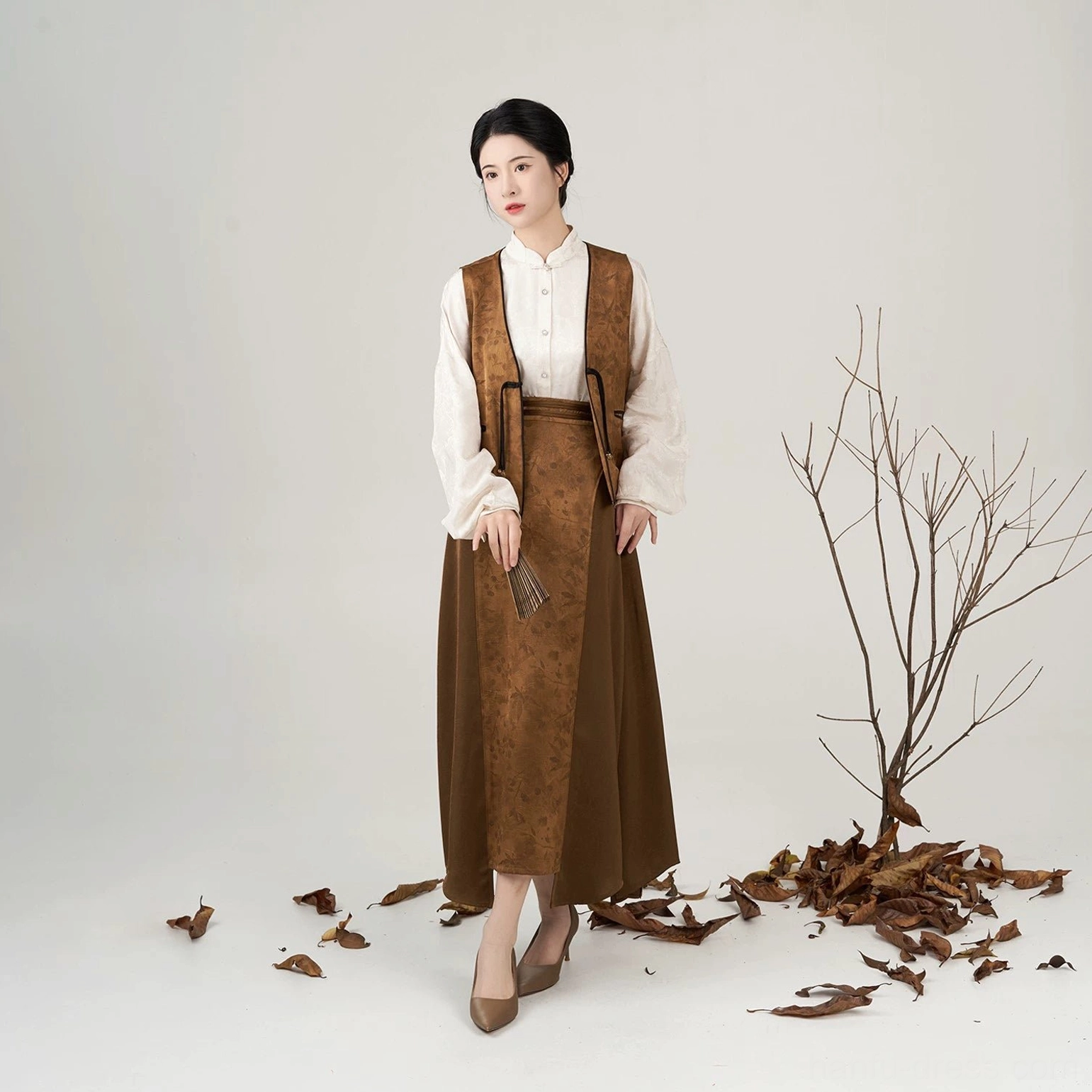 Full body front view of women modern Hanfu three-piece cream pipa sleeve shirt brown vest and long skirt set