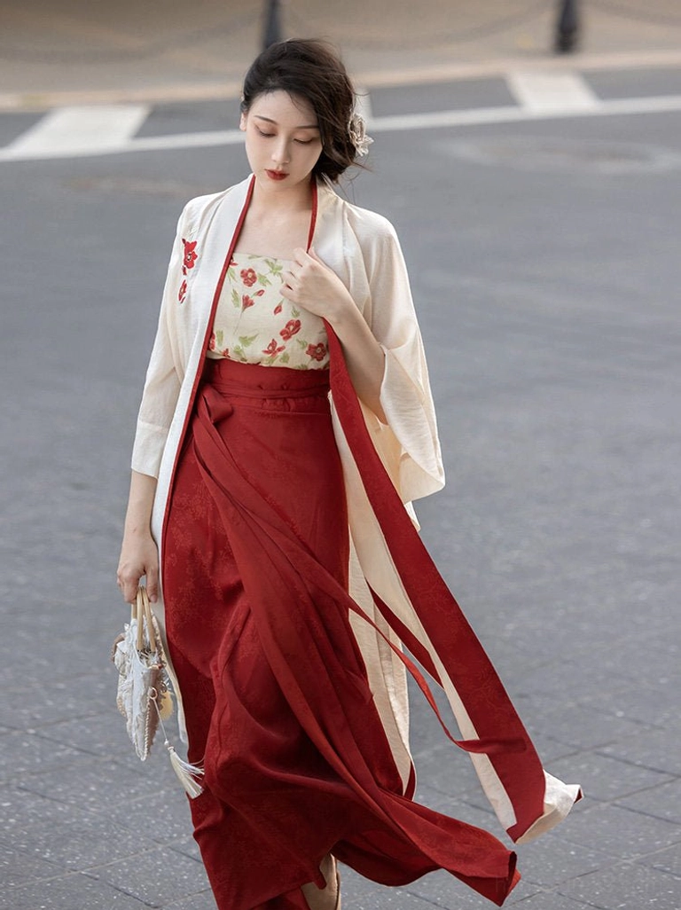 Walking front view of a modern Hanfu three-piece outfit with flowing wine-red skirt sash, beige jacket, and refined Song Dynasty style