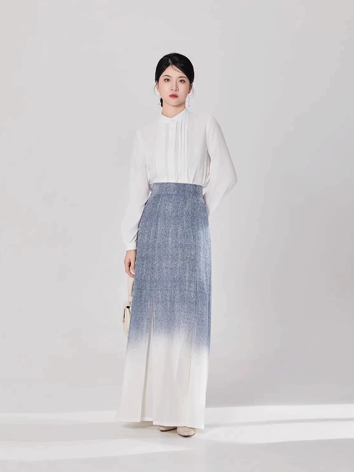 Modern Hanfu two-piece outfit shown from the front with a refined white long-sleeve blouse and flowing ombre pleated skirt