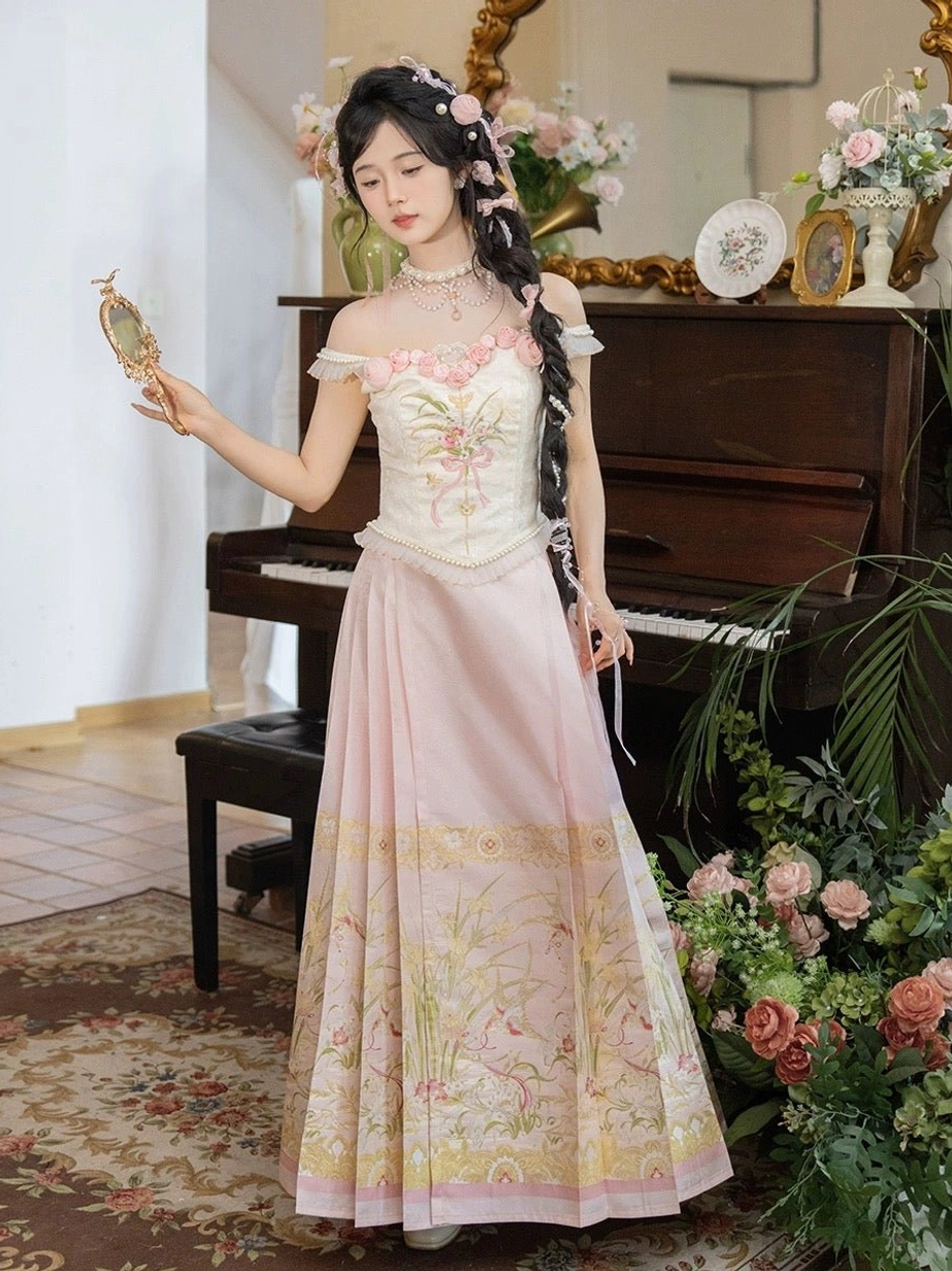 Modern Hanfu Waltz outfit beside a vintage piano, showing the cream floral embroidered corset top and flowing pink floor length Ming style mamian skirt