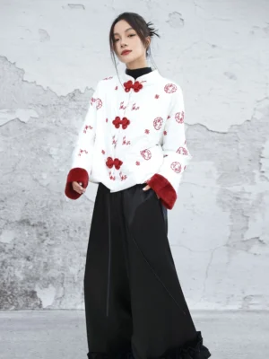 White New Chinese style embroidered padded jacket with red knotted frog buttons and red cuff trim worn with black wide-leg pants