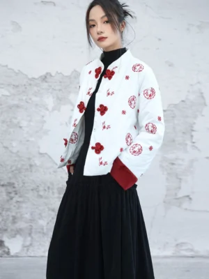 Modern Hanfu white embroidered padded jacket with red frog closures and plush red cuffs styled with a black long skirt