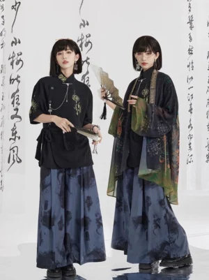 Two women styling ink wash print modern Hanfu wide leg pants with a black oblique button shirt and flowing green gradient Chinese style outer robe