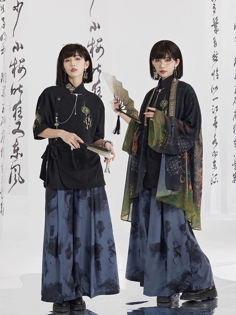 Two women styling ink wash print modern Hanfu wide leg pants with a black oblique button shirt and flowing green gradient Chinese style outer robe