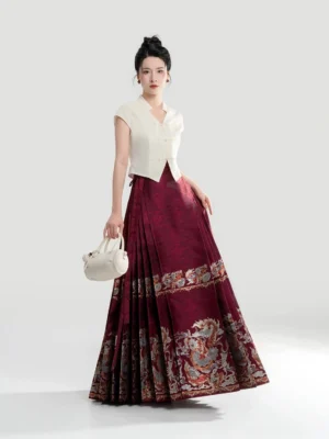 Modern Hanfu women's apricot V-neck cropped top styled with a red jacquard mamian skirt featuring golden dragon-inspired woven trim in a front three-quarter studio view
