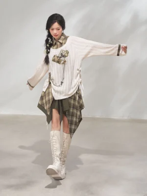 Dynamic front view of a modern Hanfu xianxia layered outfit with adjustable drawstring knit top and cropped asymmetric plaid skirt
