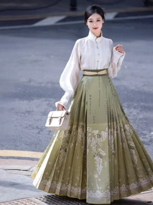 Modern Ming Dynasty Hanfu two-piece set with white stand-collar lantern sleeve shirt and sage green acacia flower mamianqun skirt worn on an urban street