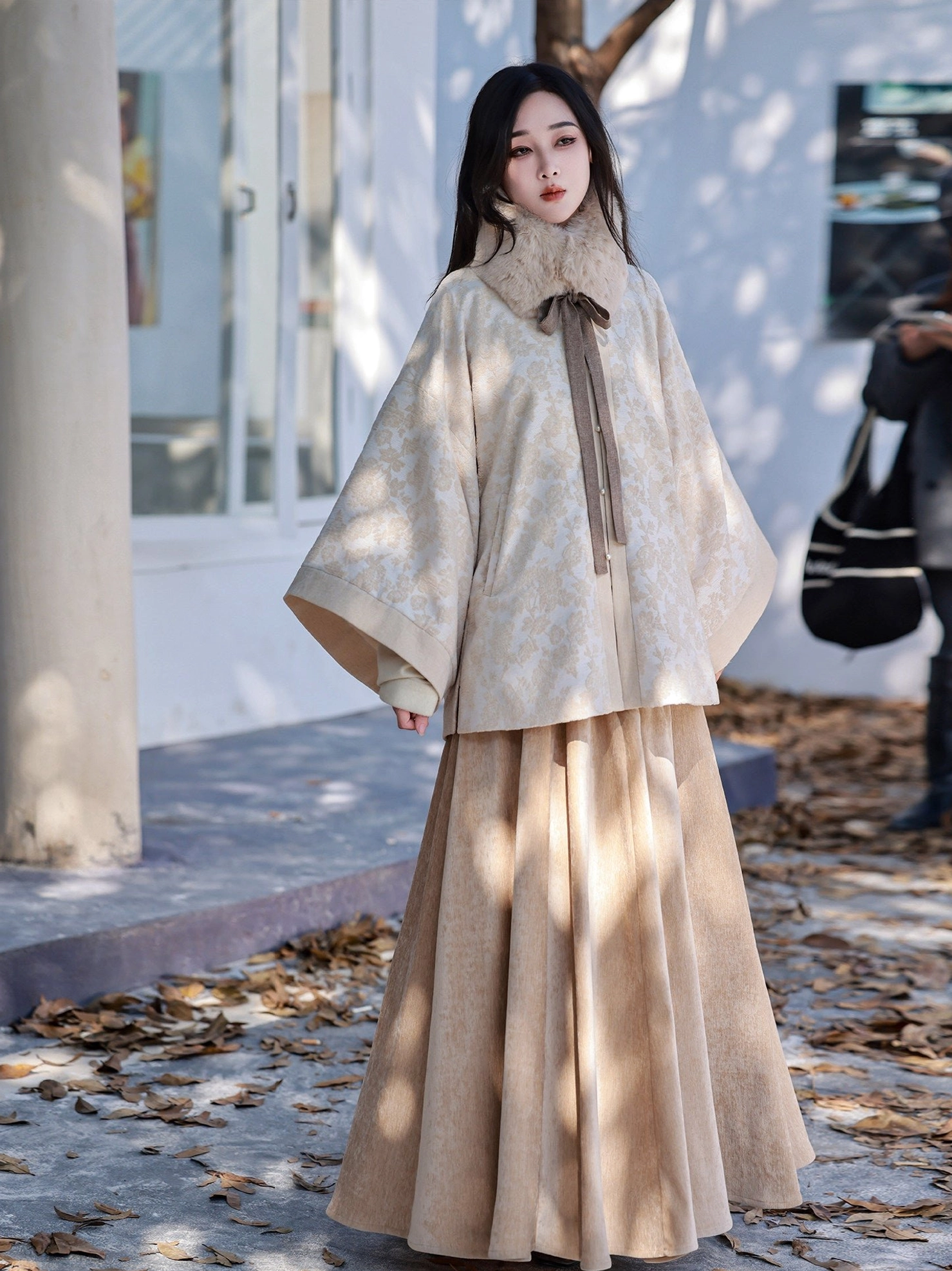 Full front view of modern Ming Dynasty Hanfu outfit with beige round collar jacket wide sleeves and tan high waisted skirt