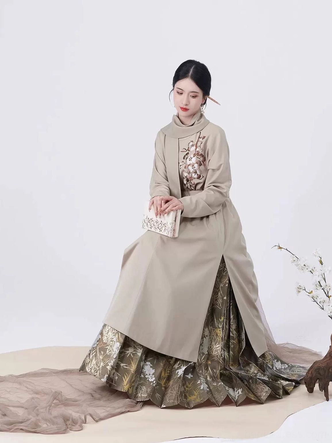 Modern Ming Dynasty Hanfu mamianqun outfit with taupe embroidered long coat, pleated gold-patterned skirt, and traditional Chinese styling
