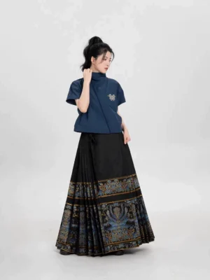 Side view of modern Ming Dynasty Hanfu outfit featuring embroidered navy cropped coat and flowing black pleated mamianqun skirt