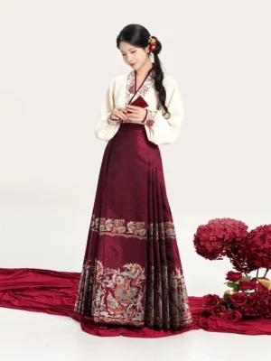 Full-body front view of a modern Ming Dynasty-inspired hanfu set with beige embroidered cross-collar top and dark red dragon-pattern mamianqun horse face skirt