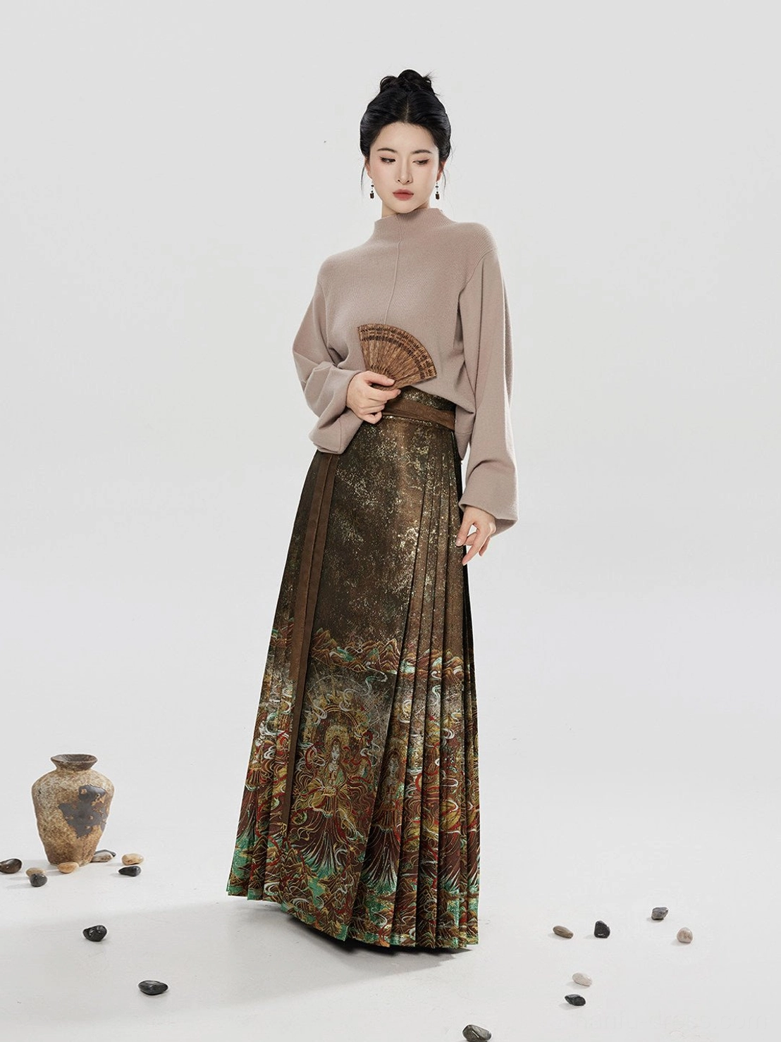 Modern Ming-style hanfu sweater and mamianqun skirt outfit with female model holding a traditional folding fan