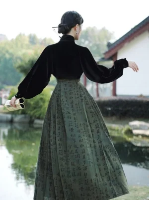 Back view of a modern Ming-inspired mamianqun outfit featuring a black velvet blouse and olive pleated horse-face skirt with Chinese calligraphy print