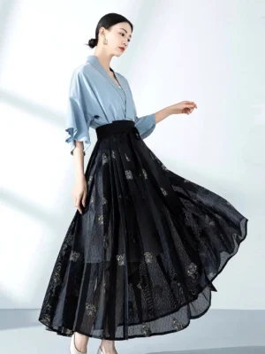 Modern Ming style mamianqun Hanfu set with light blue cross collar top and black pleated horse face skirt with gold floral embroidery