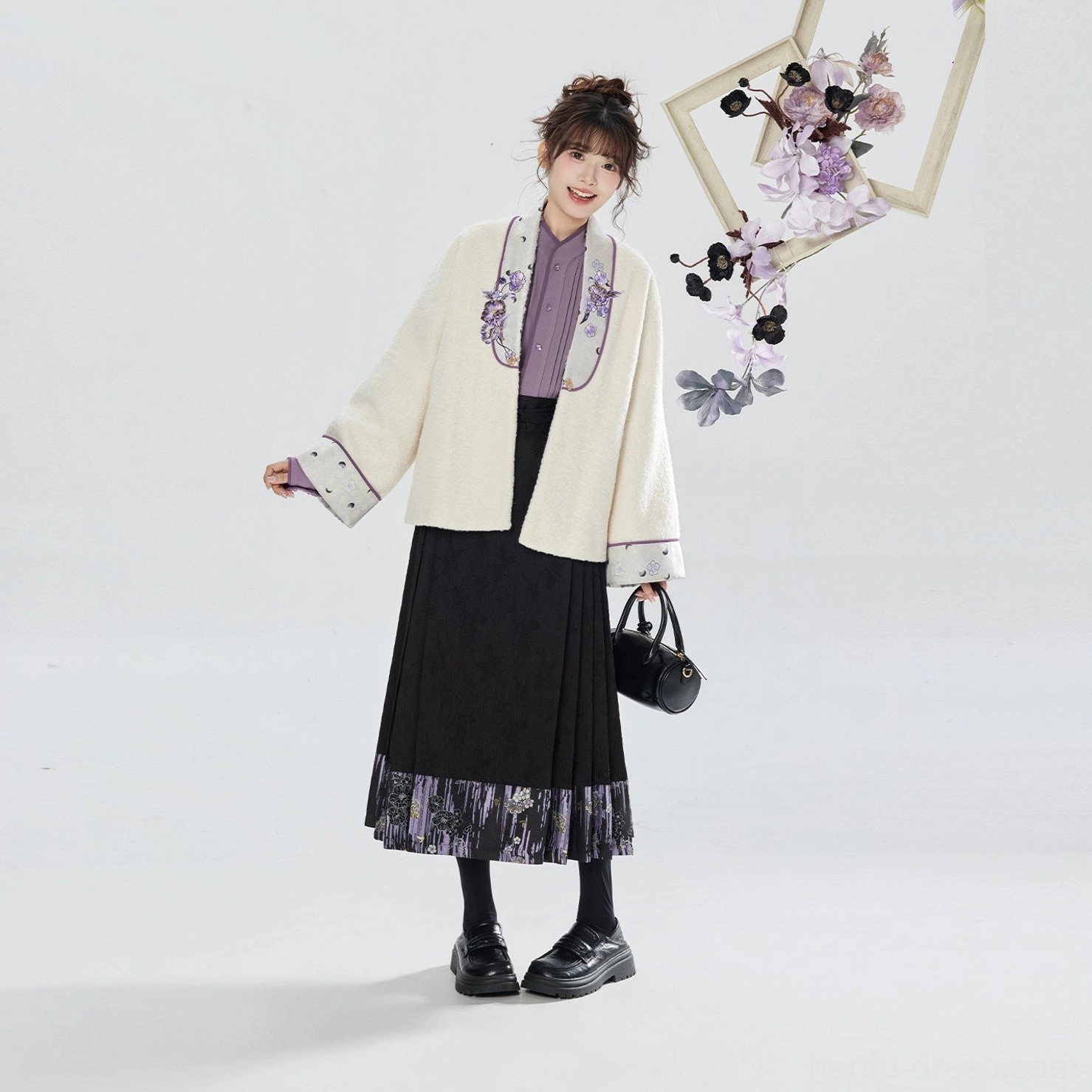 Side full-body view of a modern Ming-style hanfu three-piece outfit with relaxed cream jacket, lavender inner shirt, and flowing black pleated skirt