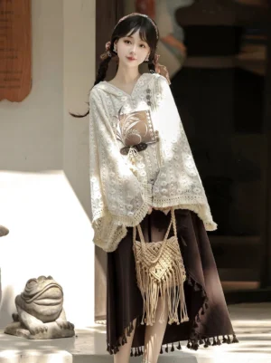 Side view of modern New Chinese style Hanfu clothing featuring a hollow floral lace hooded top with crocheted sleeve trim and matching brown tassel hem skirt